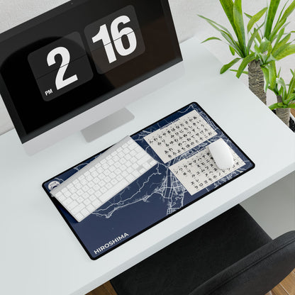 Desk setup with a keyboard and mouse on a desk mat, featuring a digital clock and plant in the background.