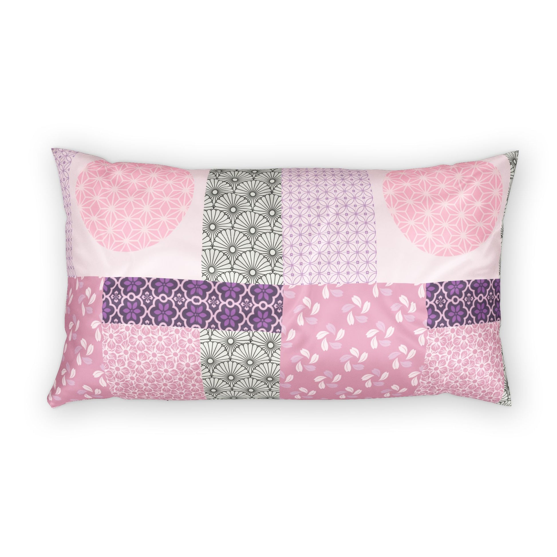 A rectangular lumbar pillow featuring a patchwork design of various pink, purple, and gray patterned fabric panels, shown against a plain white background.