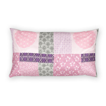 A rectangular lumbar pillow featuring a patchwork design of various pink, purple, and gray patterned fabric panels, shown against a plain white background.