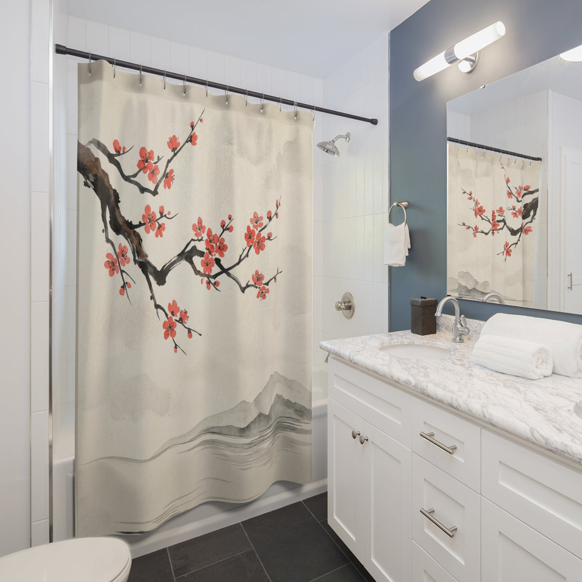 A shower curtain with a traditional Chinese-style print of red cherry blossoms and gray mountains, hanging in a modern white and blue-gray bathroom.