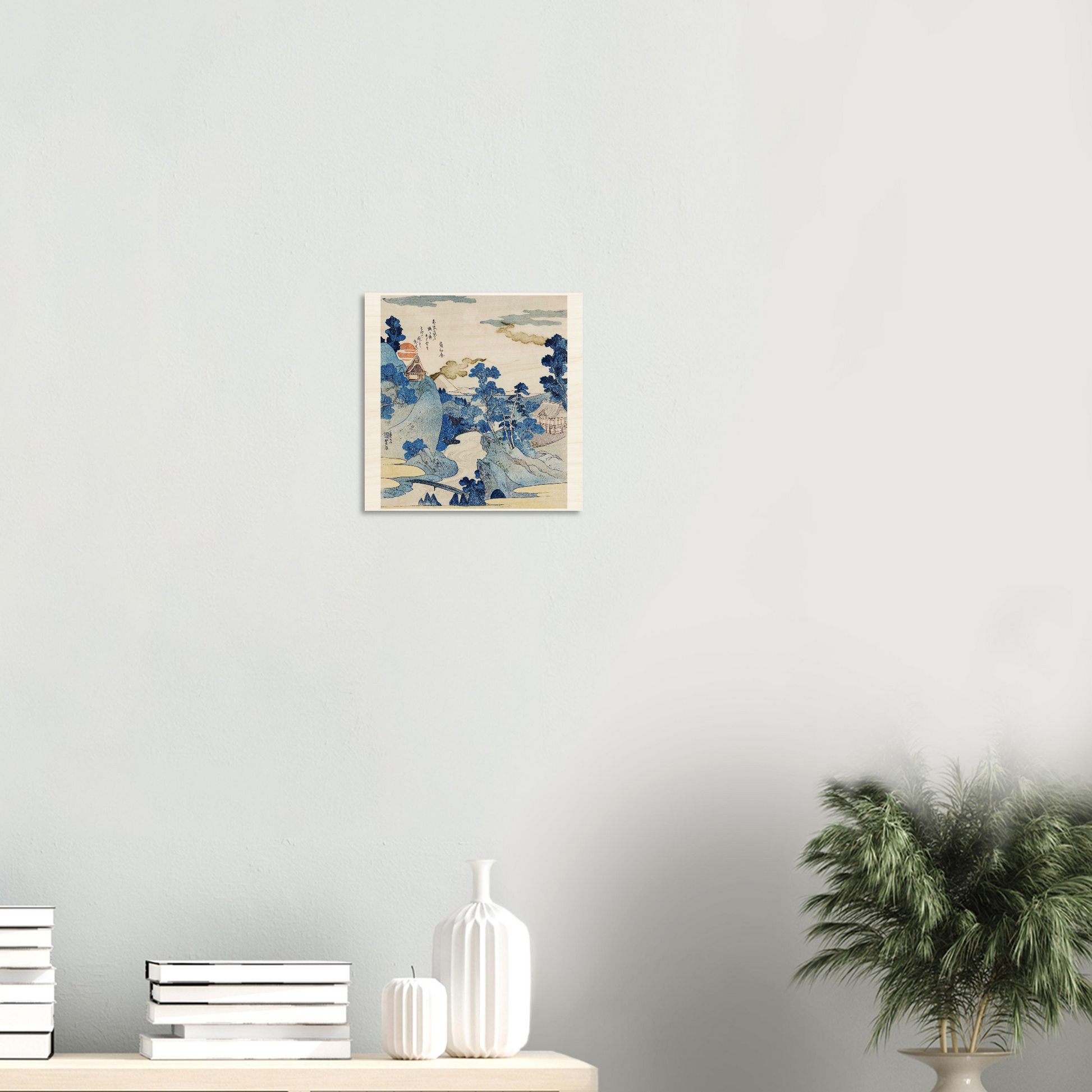 Framed artwork of a woman's face on a wall above a console table with decorative items.