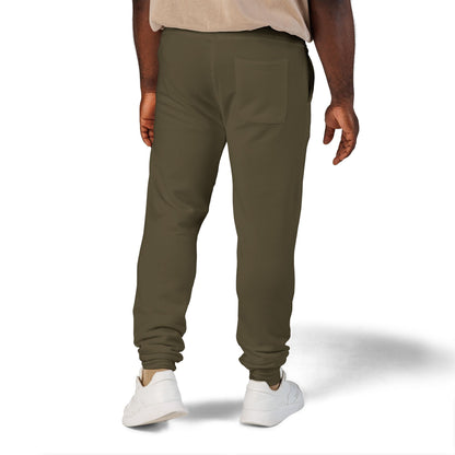 Person wearing olive green jogger pants on a white background
