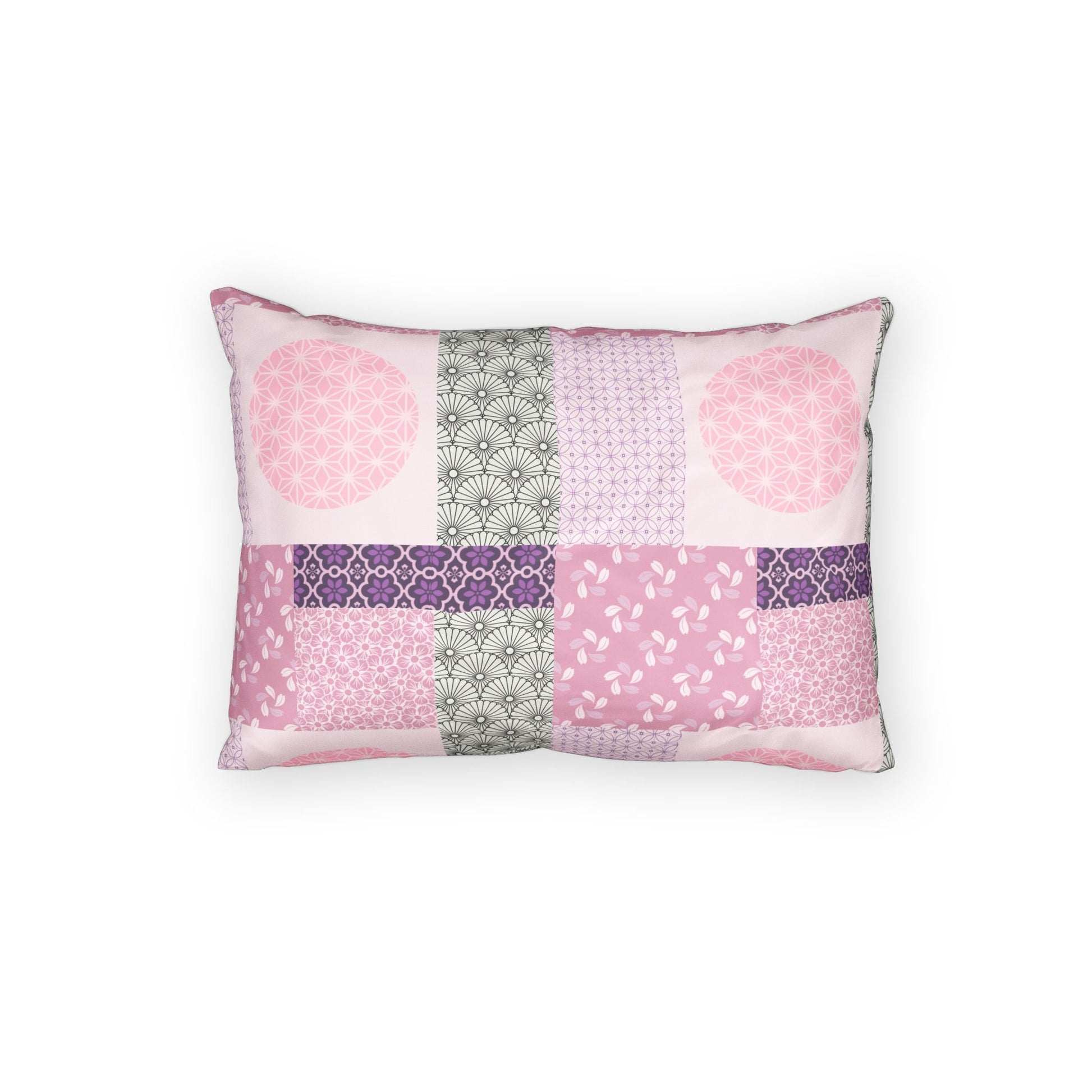 A rectangular throw pillow featuring a patchwork design of various pink, purple, and gray patterned fabric squares, set against a plain white background.