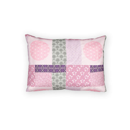 A rectangular throw pillow featuring a patchwork design of various pink, purple, and gray patterned fabric squares, set against a plain white background.