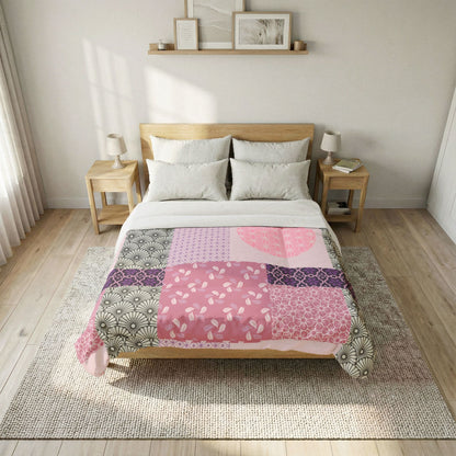 Bed with a colorful patchwork quilt in a bedroom setting. Cotton Heritage