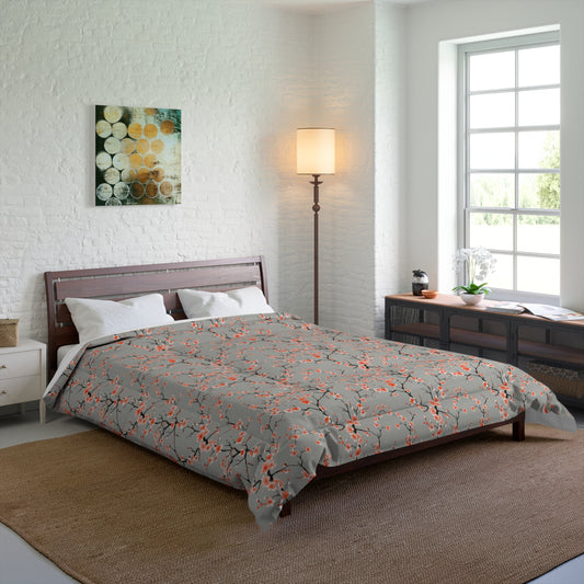 Bedroom with a bed featuring a gray comforter with orange floral patterns, a lamp, and a painting on the wall.