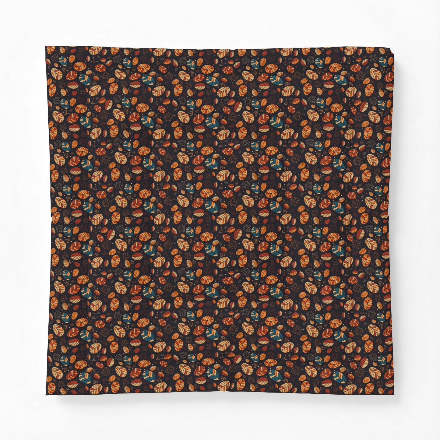A square fabric item, likely a bandana or scarf, featuring an all-over dense pattern of small illustrated faces in orange, brown, and teal on a very dark background, displayed flat against a light gray backdrop.