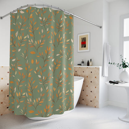 A sage green shower curtain with a repeating pattern of orange, gold, and cream autumn leaves, hanging on a curved silver rod in a bright, modern bathroom.