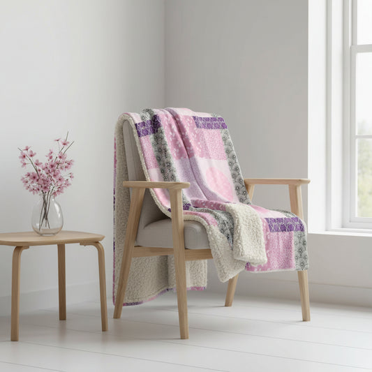 Pink and purple patterned blanket with geometric design on a white background