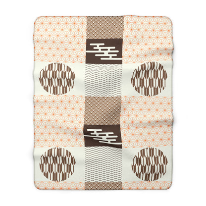 Patchwork blanket with geometric patterns on a white background