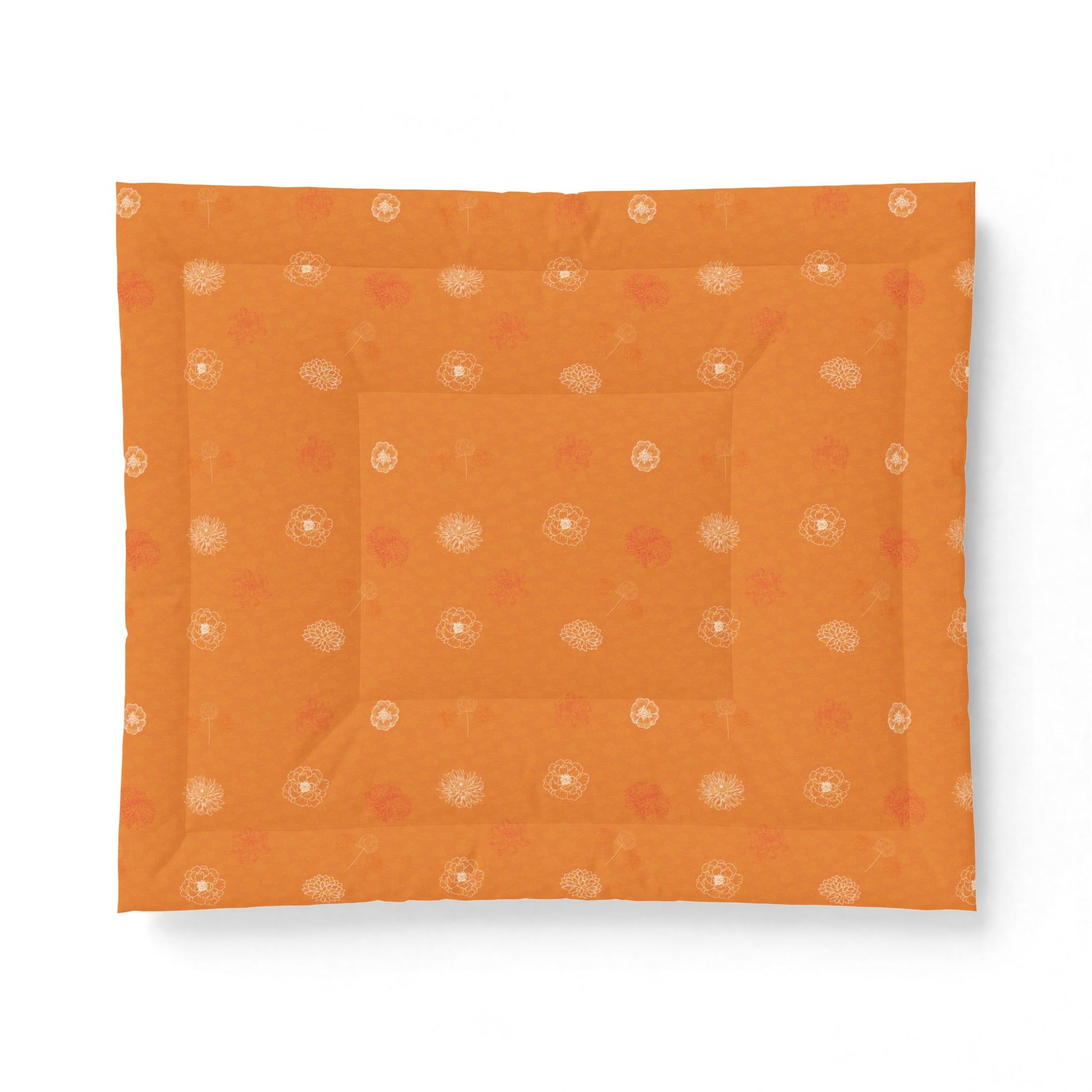 An orange square fabric item, likely a quilt or comforter, featuring a subtle pattern of small white and muted red floral motifs, displayed flat against a white background.