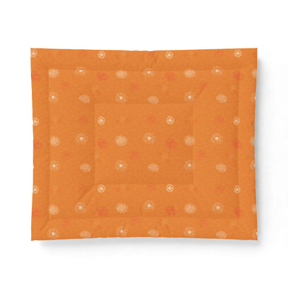 An orange square fabric item, likely a quilt or comforter, featuring a subtle pattern of small white and muted red floral motifs, displayed flat against a white background.