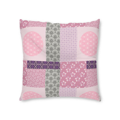 A square decorative throw pillow featuring a patchwork design of various pink, purple, and gray geometric and floral patterns on a white background.
