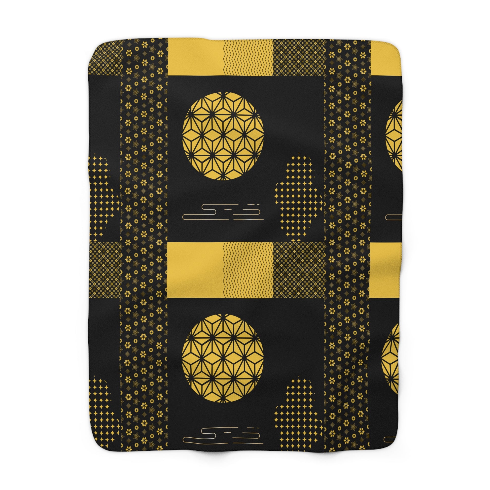 Black blanket with gold geometric patterns on a white background