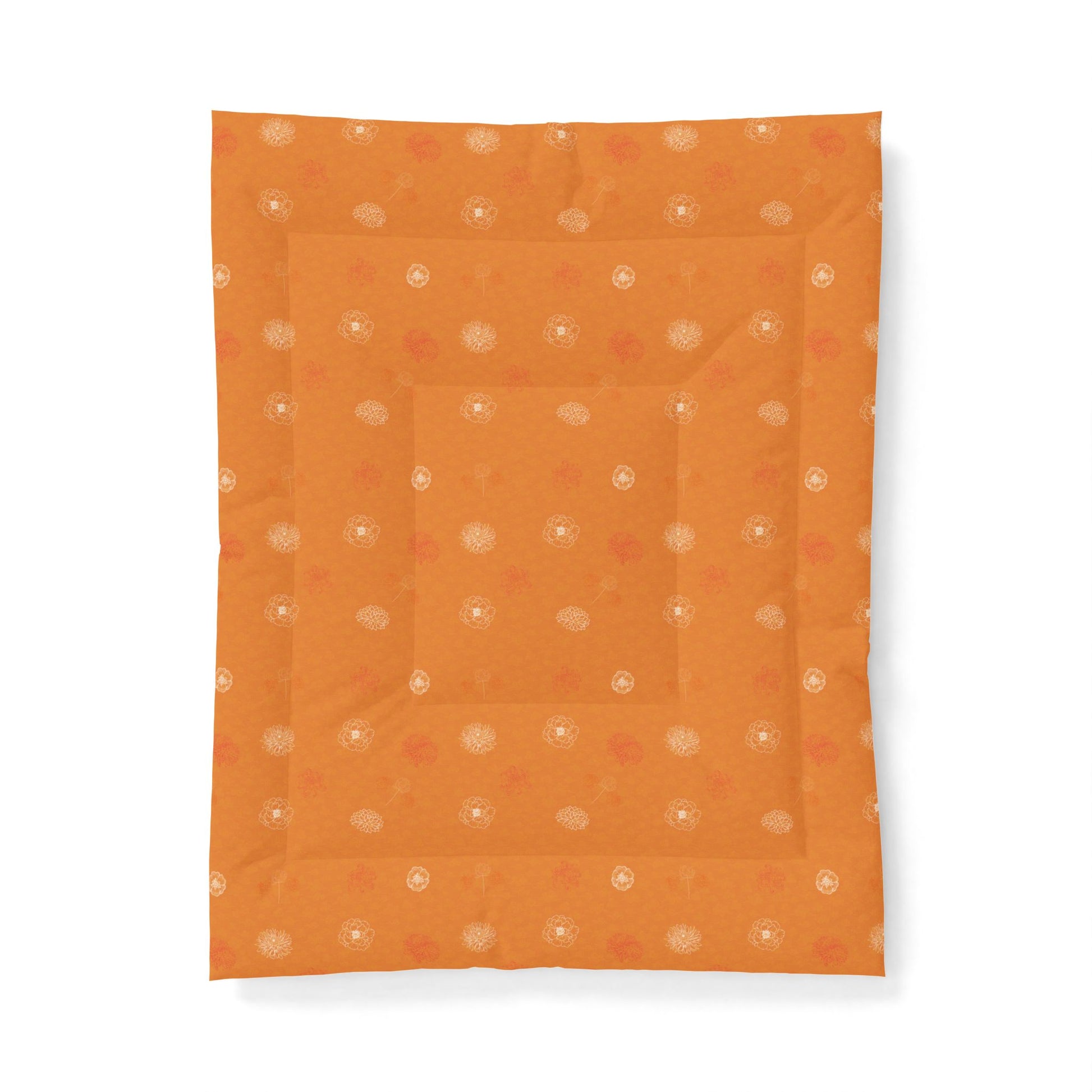 An orange quilted baby blanket with a subtle pattern of small white and orange dots, shown flat against a white background.