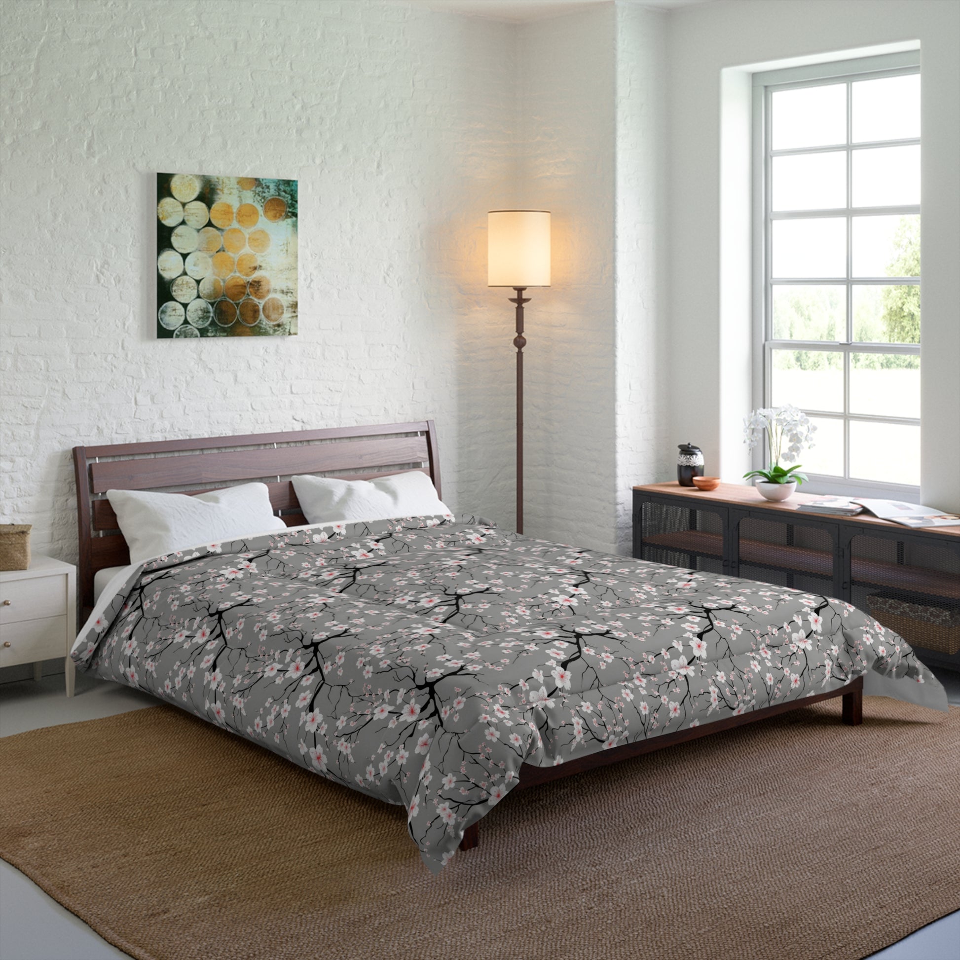 Bedroom with floral comforter on bed, lamp, and artwork on wall.