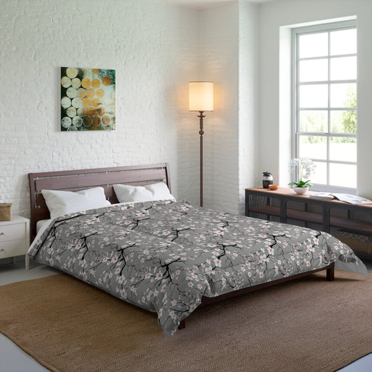 Bedroom with floral comforter on bed, lamp, and artwork on wall.