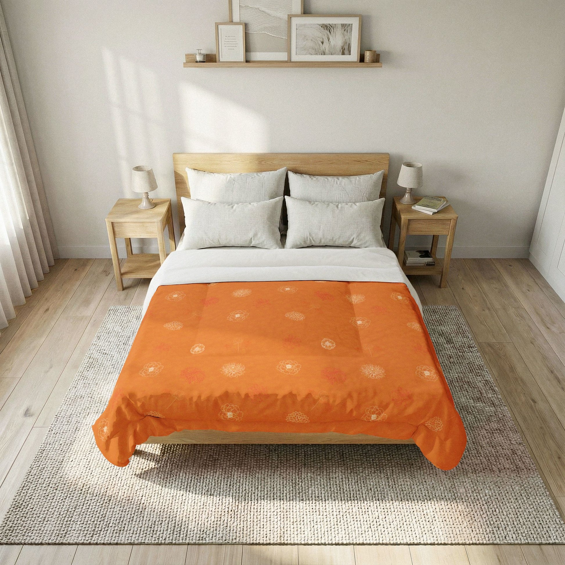 An orange patterned duvet cover with white sun motifs is styled on a wooden bed frame in a bright, modern bedroom setting with white pillows, bedside tables, and a neutral rug.