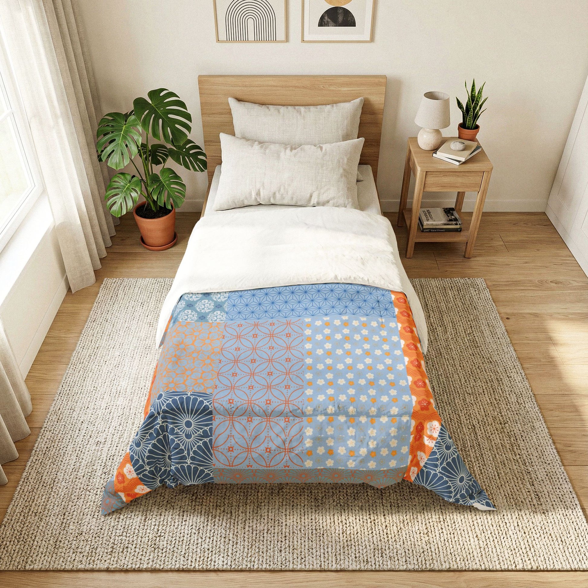 Bedroom with a bed featuring a colorful geometric patterned comforter, nightstand, and plants. Heritage Cotton