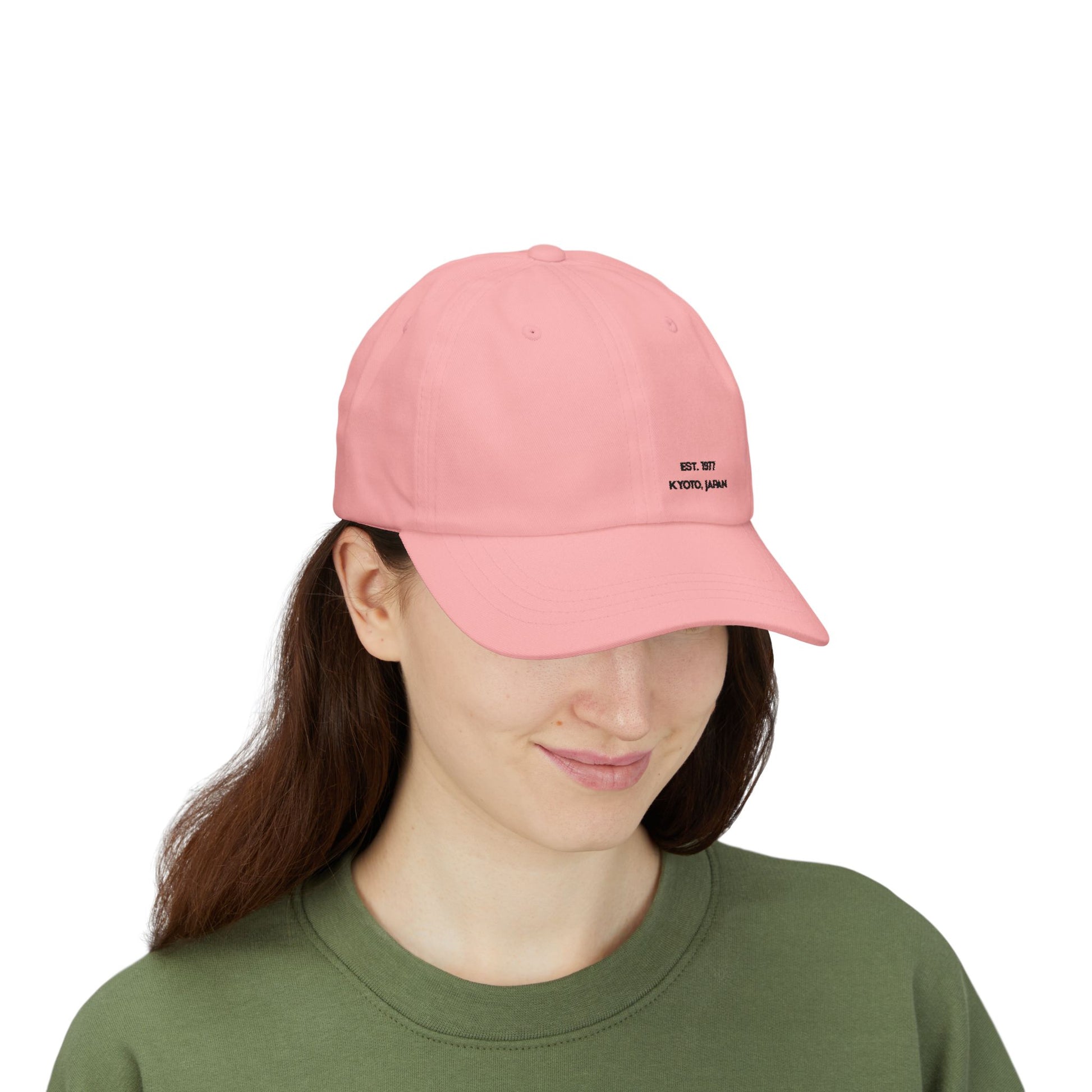 Person wearing a pink cap with 'Professional Chaos Coordinator' text on a white background