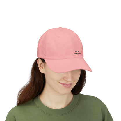 Person wearing a pink cap with 'Professional Chaos Coordinator' text on a white background