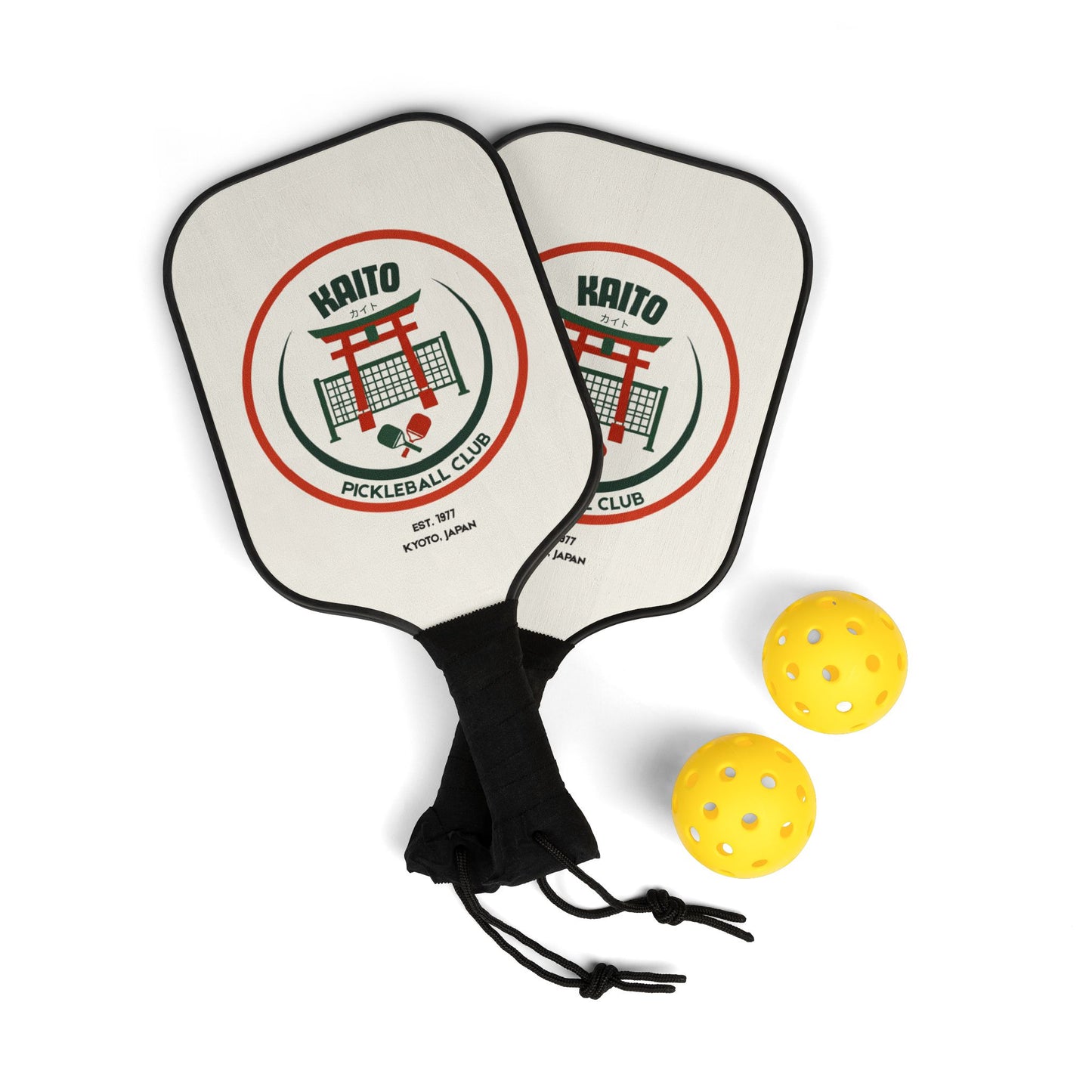 Two pickleball paddles with a logo and three yellow balls on a white background