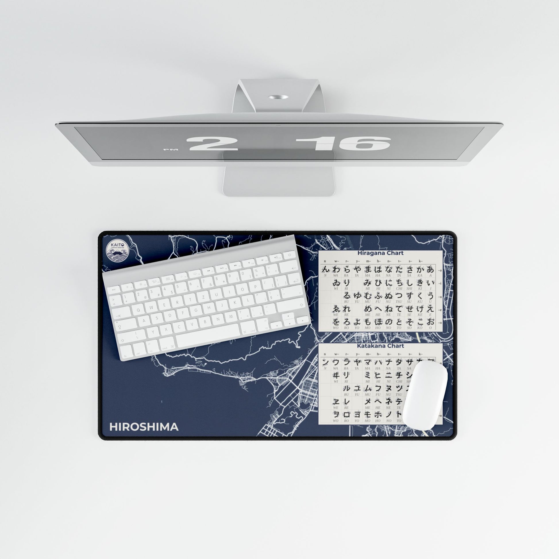Desk setup with a monitor, keyboard, and desk pad featuring Hiroshima map design on a white background.
