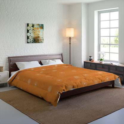 An orange patterned comforter with white pillows on a dark wood bed frame in a modern, bright bedroom setting.