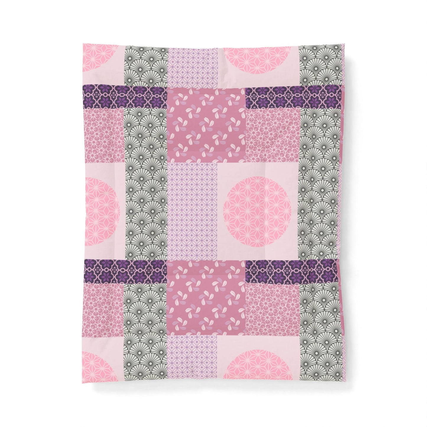 Patchwork patterned fabric with pink, purple, and green colors on a white background