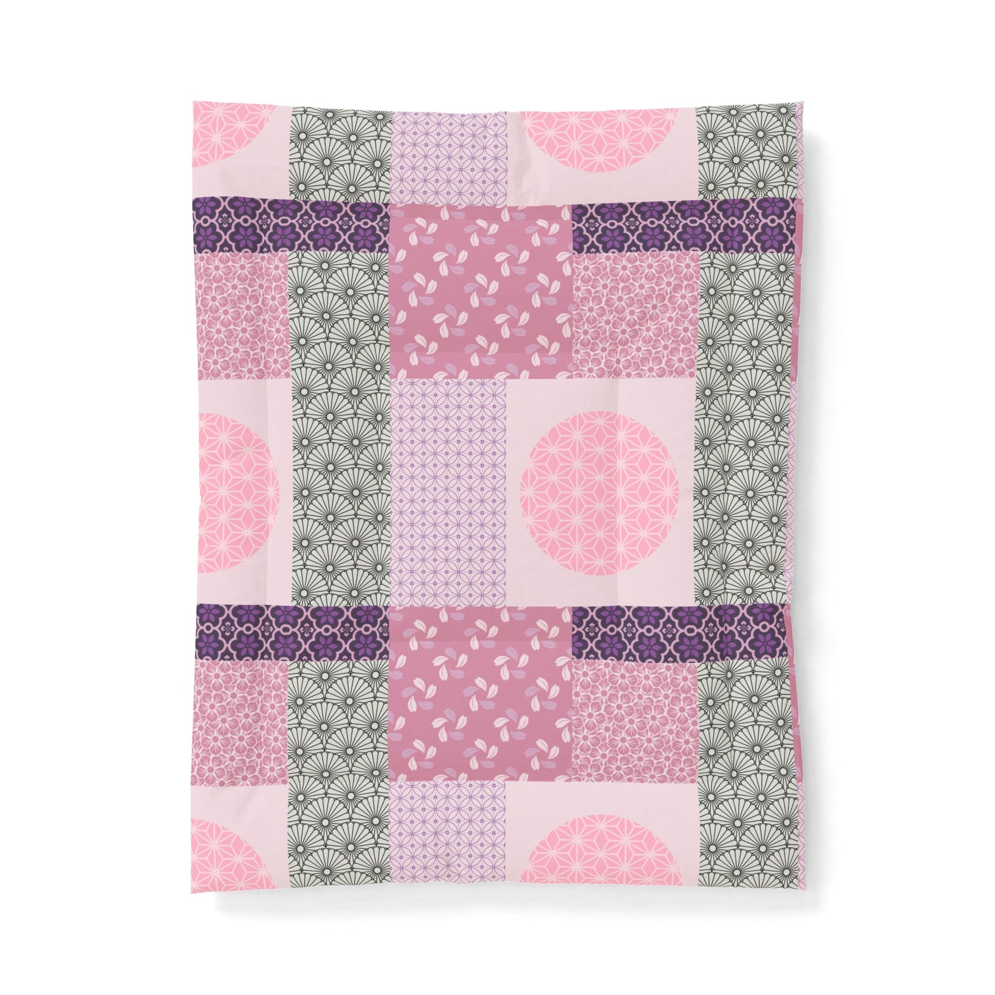 Patchwork patterned fabric with pink, purple, and green colors on a white background
