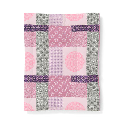 Patchwork patterned fabric with pink, purple, and green colors on a white background