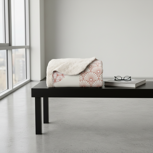 Patterned blanket on a black bench in a room with large windows