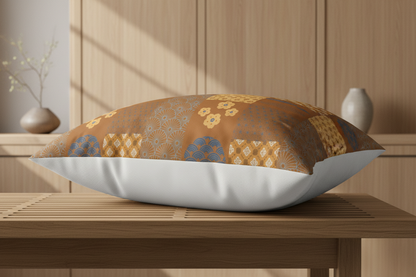 An elegantly styled 100% cotton pillow sham from the Kaito Autumn Harvest collection, showcasing a geometric brown and blue Japanese Wagara patchwork design on the front and a solid white back