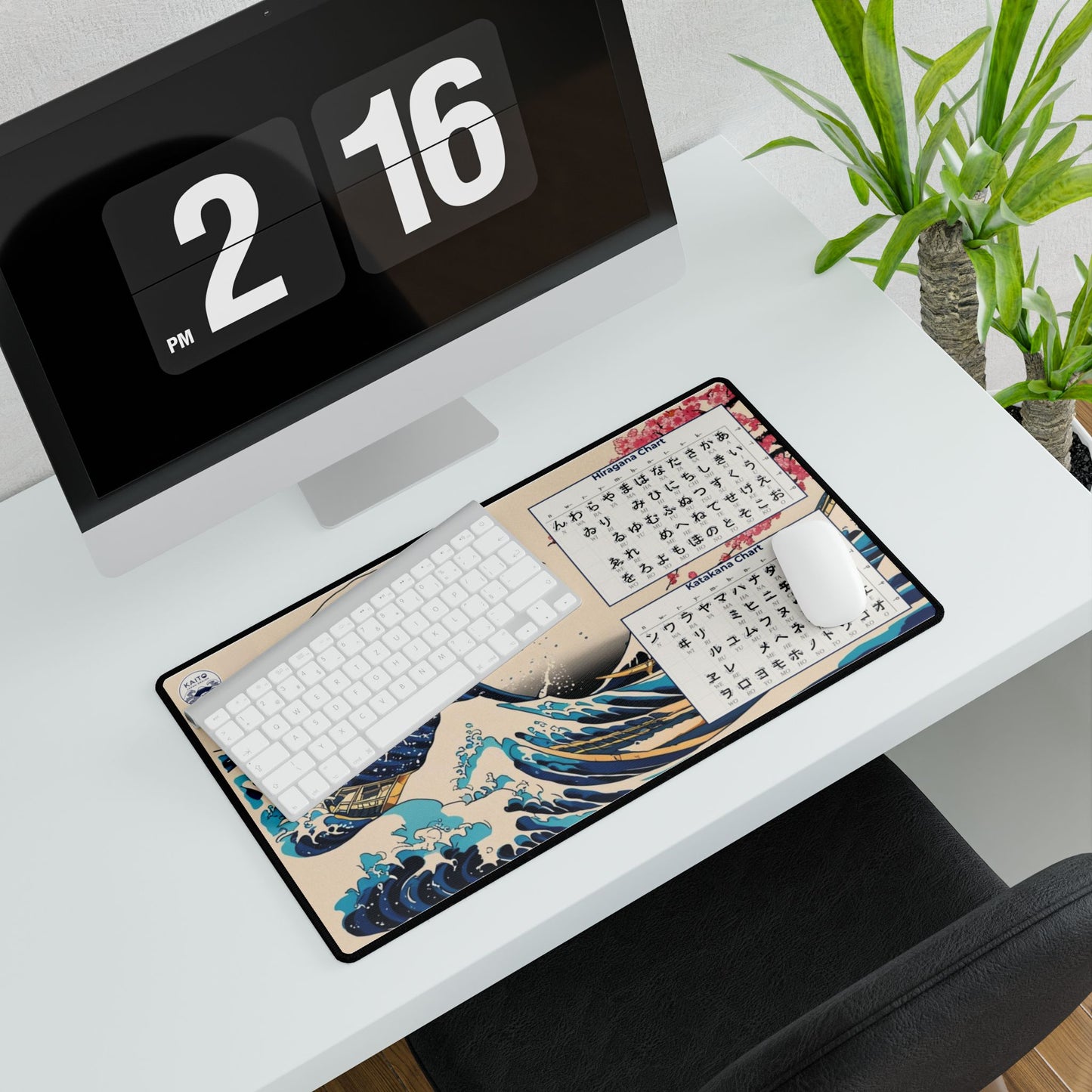 Desk setup with a large mouse pad featuring artistic designs, a keyboard, and a digital clock.