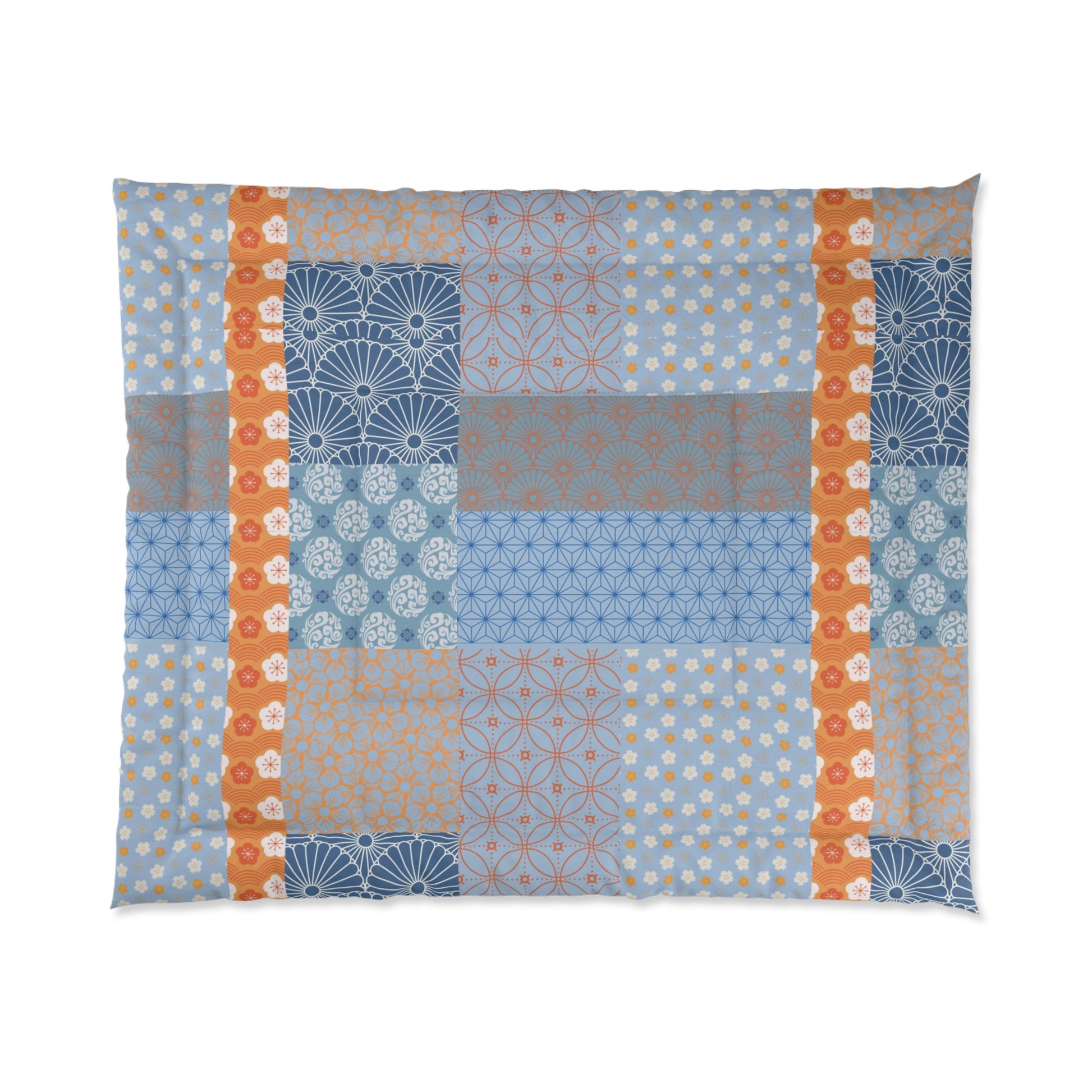 Patchwork quilt with geometric patterns in blue, orange, and brown on a white background. 