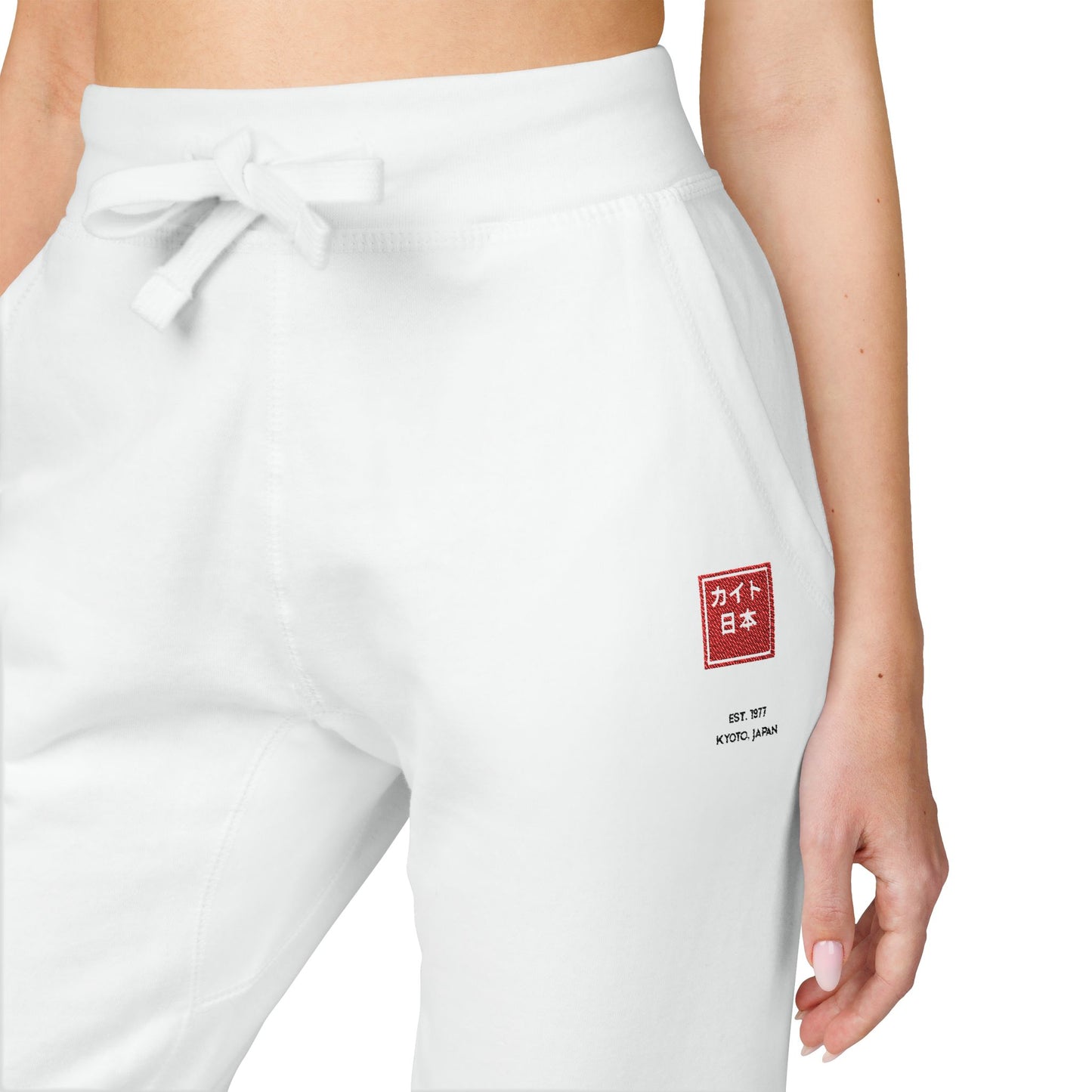 White sweatpants with a red and white logo on a white background