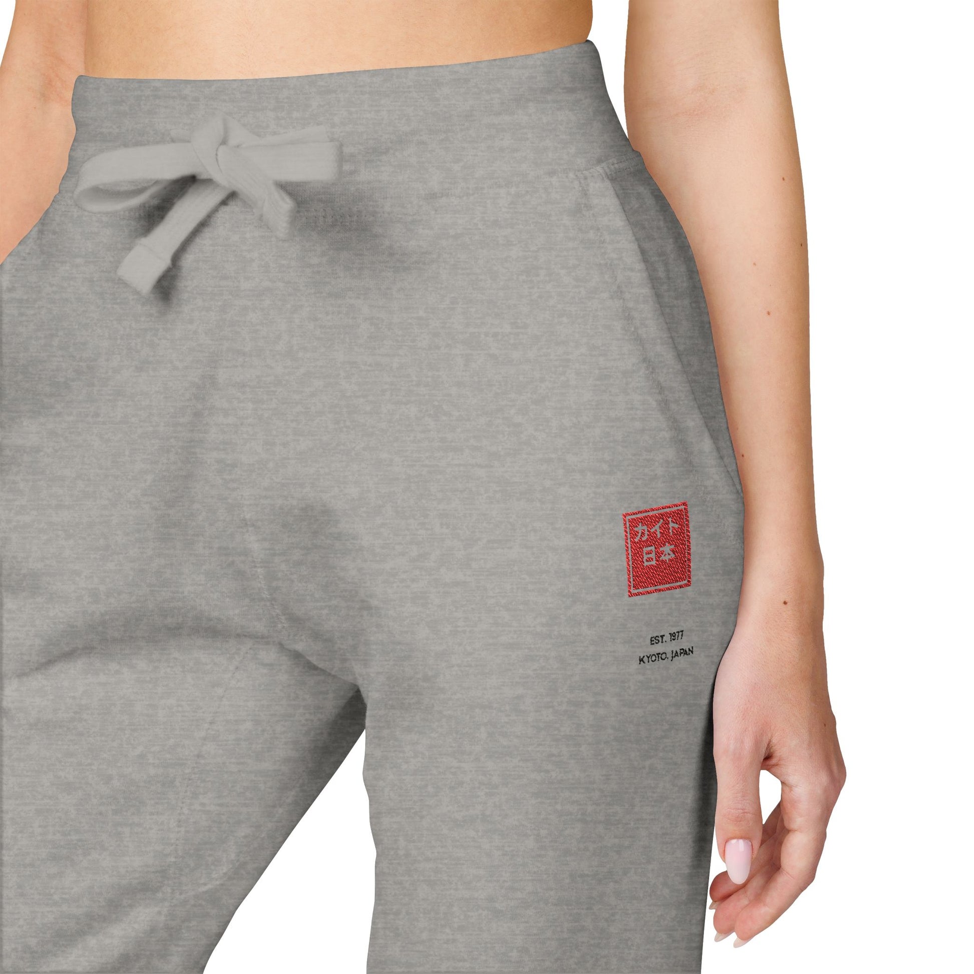Gray sweatpants with a red logo on a white background