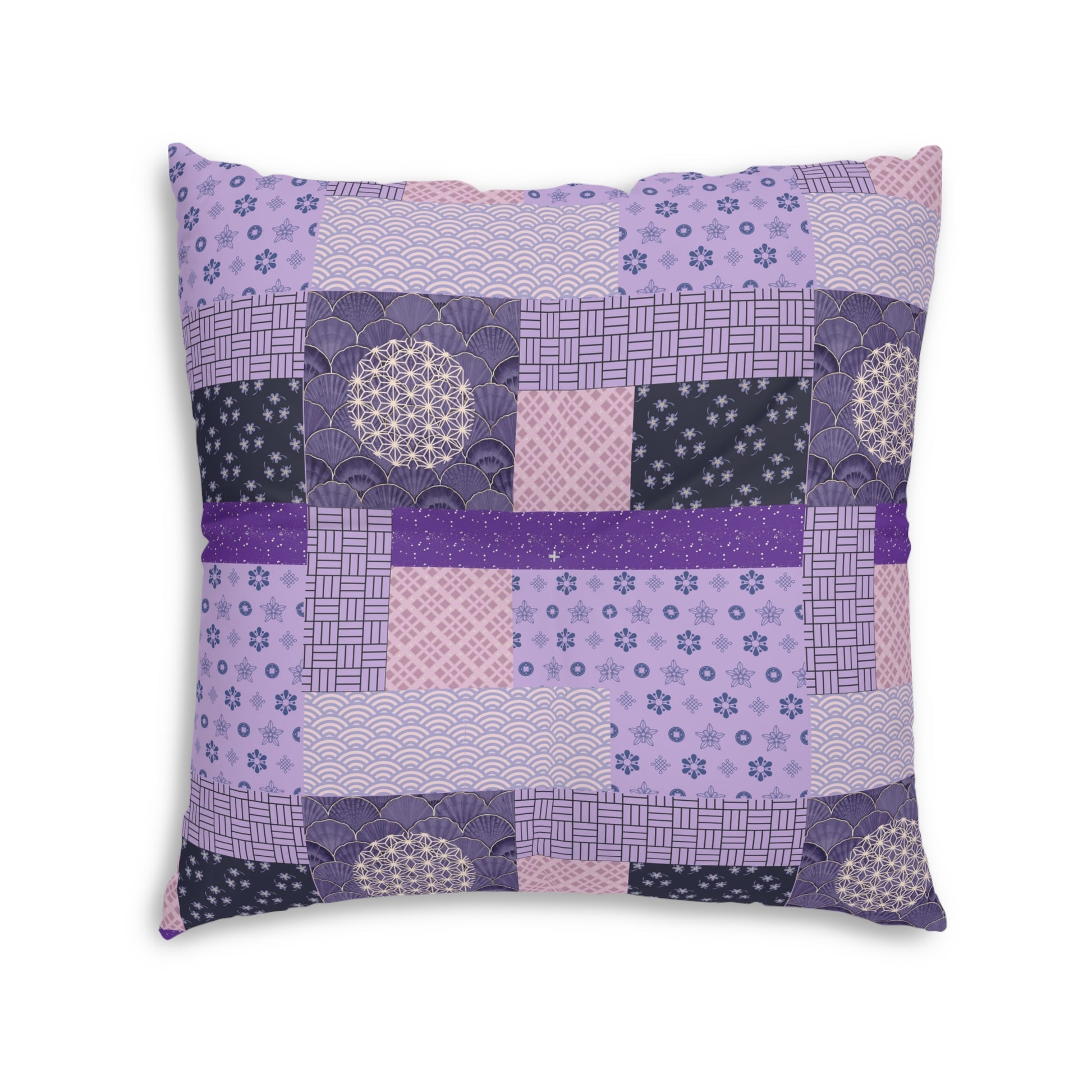 A square decorative throw pillow featuring a patchwork design of various Japanese-inspired patterns in shades of purple, pink, and navy blue, set against a plain white background.