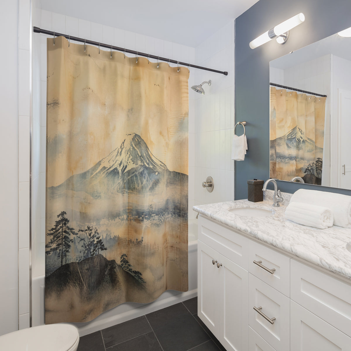 A fabric shower curtain featuring a traditional Japanese-style landscape print of Mount Fuji, hanging in a modern white and blue-gray bathroom.