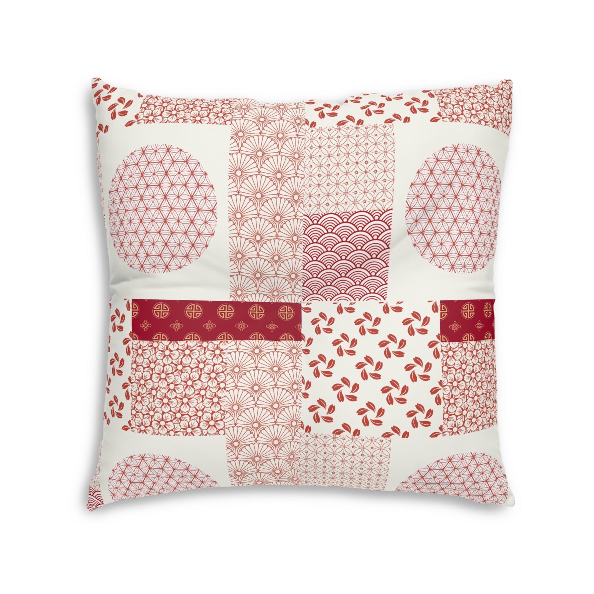 A square decorative throw pillow featuring a patchwork design of various Japanese-inspired patterns in shades of red, pink, and white on an off-white background.