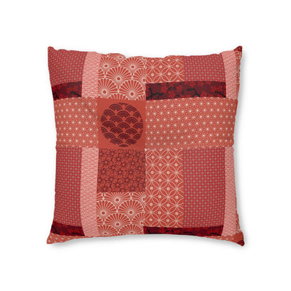 A square decorative throw pillow featuring a patchwork design of various Japanese-inspired patterns in shades of red, terracotta, and pink, set against a plain white background.