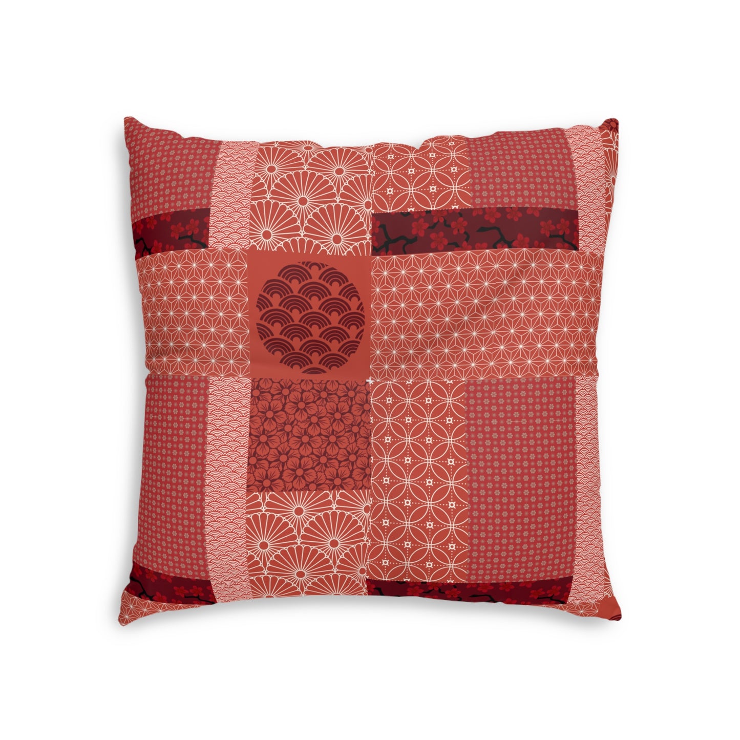 A square decorative throw pillow featuring a patchwork design of various red and pink Japanese patterns, including waves, fans, and geometric motifs, set against a plain white background.