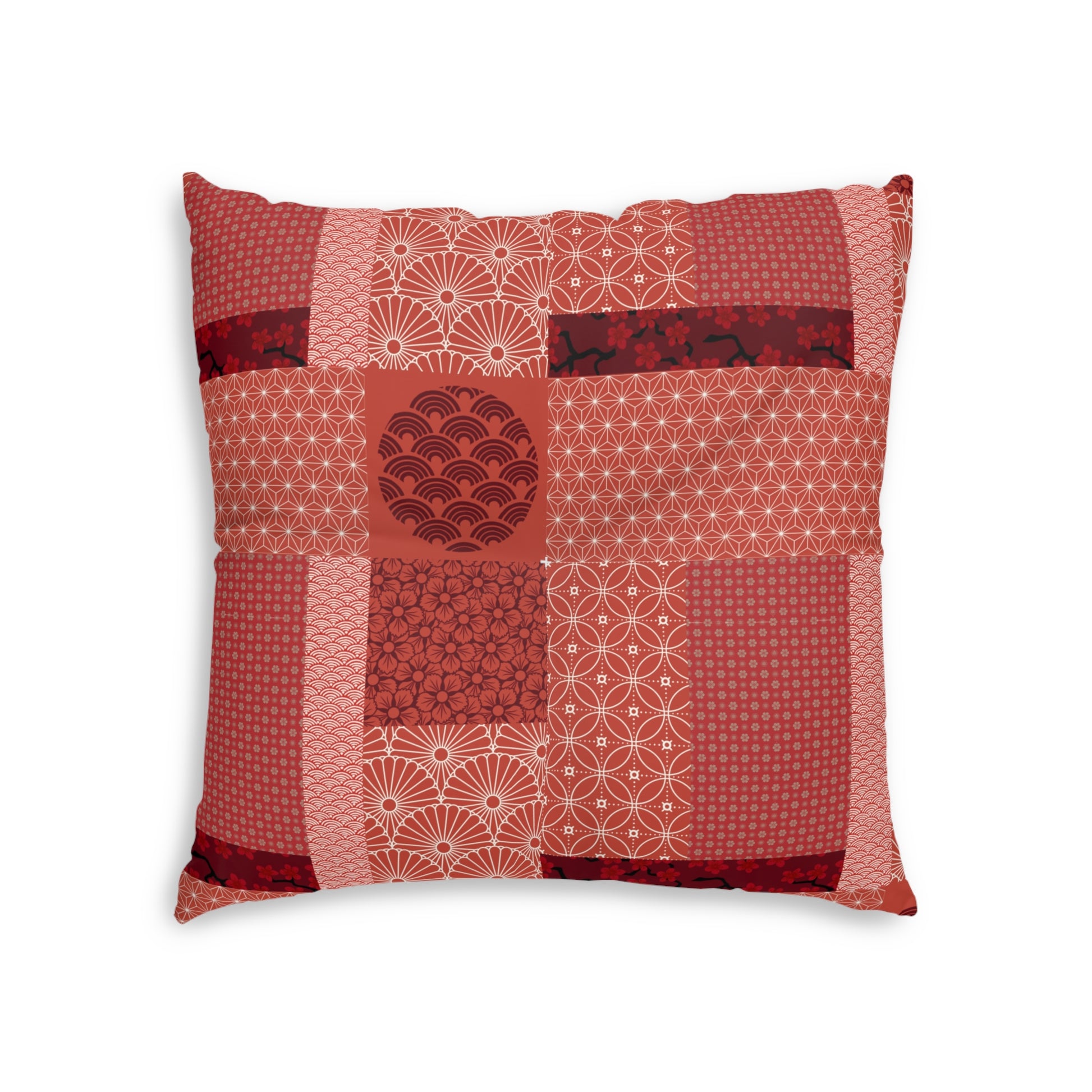 A square decorative throw pillow featuring a patchwork design of various red and pink Japanese patterns, including waves, fans, and geometric motifs, set against a plain white background.