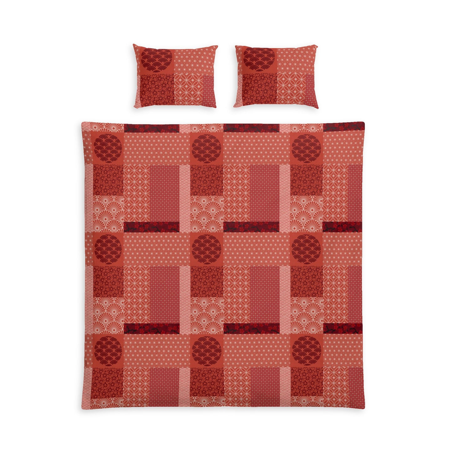 A bedding set featuring a patchwork quilt and two matching pillowcases in a warm red and orange geometric pattern, displayed on a clean white background.