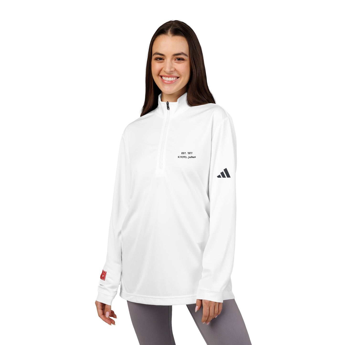 Woman wearing a white Adidas long-sleeve shirt on a white background