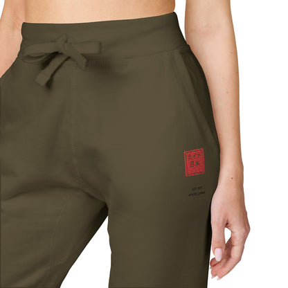 Maroon pants with a tie waist on a white background