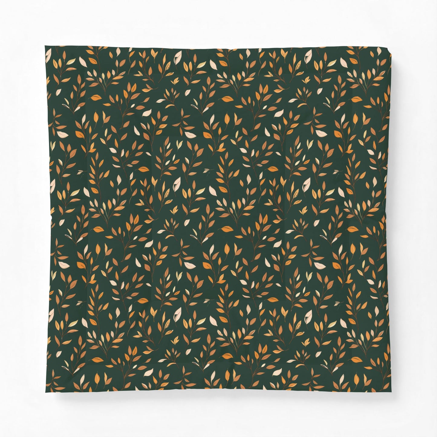 A square fabric item, likely a pillowcase or blanket, featuring an all-over repeating pattern of small leafy branches in warm orange, mustard, and cream on a dark forest green background.