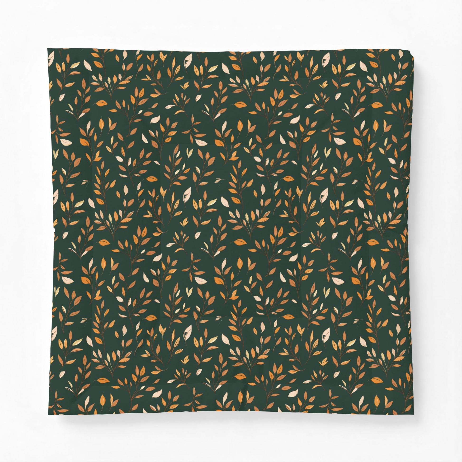 A square fabric item, likely a pillowcase or blanket, featuring an all-over repeating pattern of small leafy branches in warm orange, mustard, and cream on a dark forest green background.