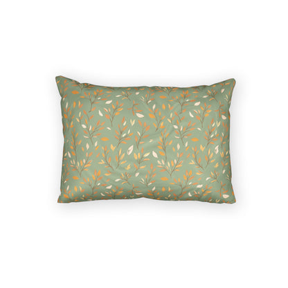 A rectangular throw pillow with a sage green background and a repeating pattern of delicate branches in mustard yellow and off-white, shown against a plain white background.
