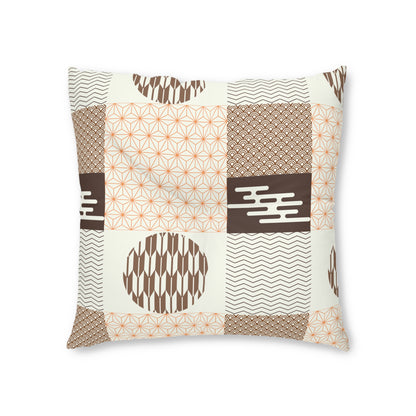 A square throw pillow featuring a patchwork design of geometric and wavy patterns in brown, orange, and white.